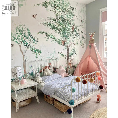 White metal bed frame with colorful pom-pom tassels paired with woodland animals mural wallpaper by artist katie 180gsm non-woven