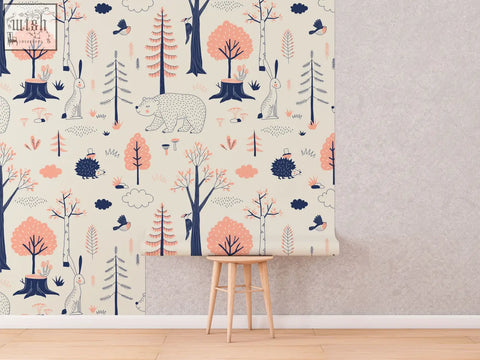 Beige traditional paper wallpaper with woodland animals kids pattern featuring pink and navy trees for nursery walls