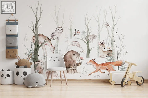 White chair with wooden legs next to colorful woodland forest wall decals for kids nursery decor