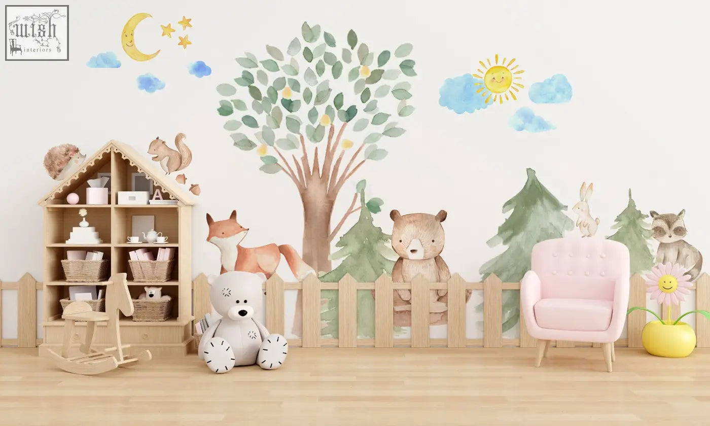 Pink tufted armchair next to woodland watercolour oak pine tree wall decals with bear fox raccoon rabbit and squirrel animals