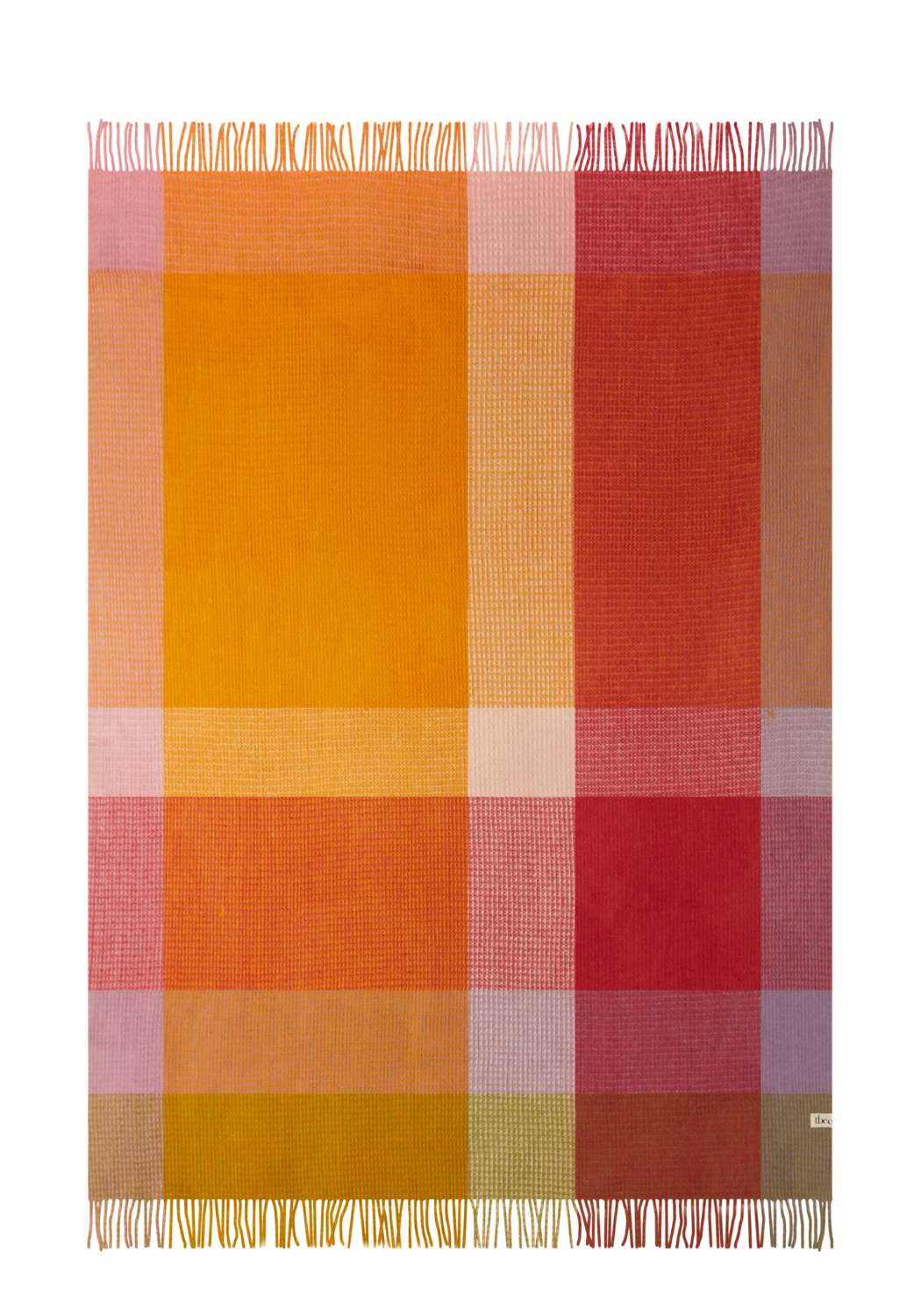 A warm wool waffle blanket in orange pink check with a woven plaid pattern and fringed edges perfect for cozy use