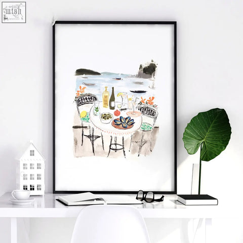 Black-framed watercolor wall art of seaside dining scene perfect for work office wall and office wall art decor