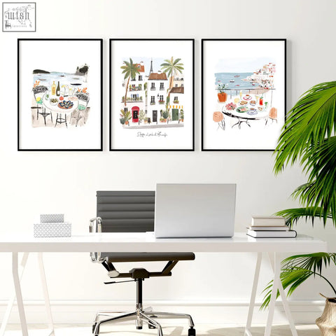 Three framed watercolor coastal scenes wall art hanging above a white desk for work office wall decoration