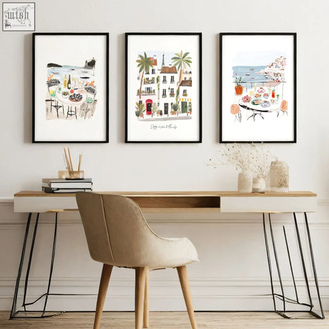 Beige upholstered chair with wooden legs next to work office wall art mediterranean coastal café scenes set of 3