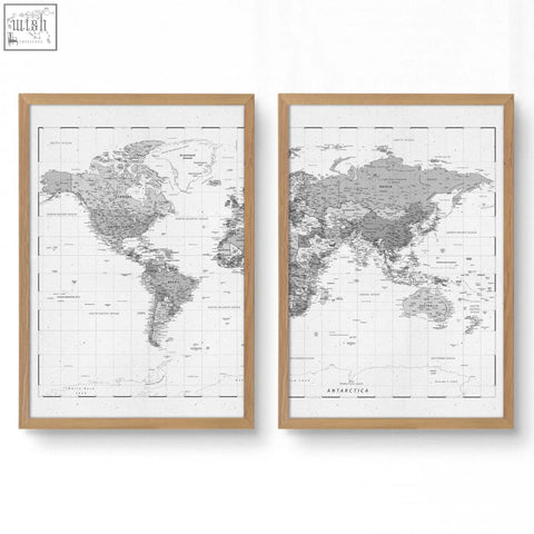 Two framed world map prints in light wood frames featuring detailed grey cartography on white paper