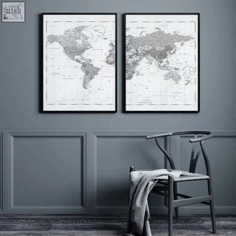 Two minimalist black and white world map prints with detailed cartography hang side by side on a grey wall