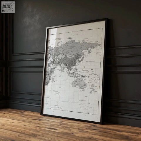 A sleek black framed world map print with minimalist grayscale continents and labels on white background set of 2