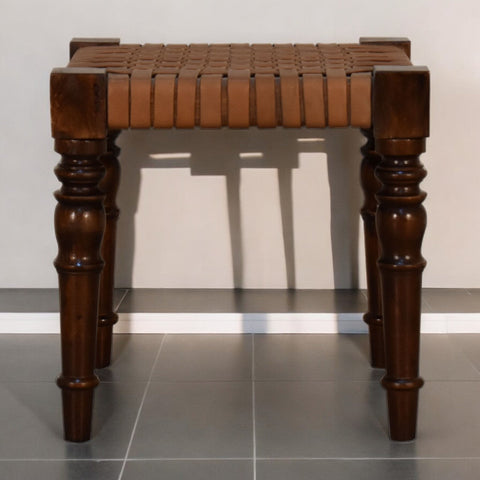 Woven leather footstool with brown leather-wrapped turned legs and woven seat made from chestnut solid mango wood