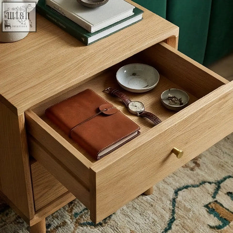 Brown leather journal with metal clasp inside open drawer of solid oak wright oak bedside table