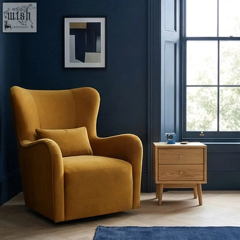 Golden velvet wingback armchair with plush cushion shown next to solid oak bedside table for stylish oak bedside use