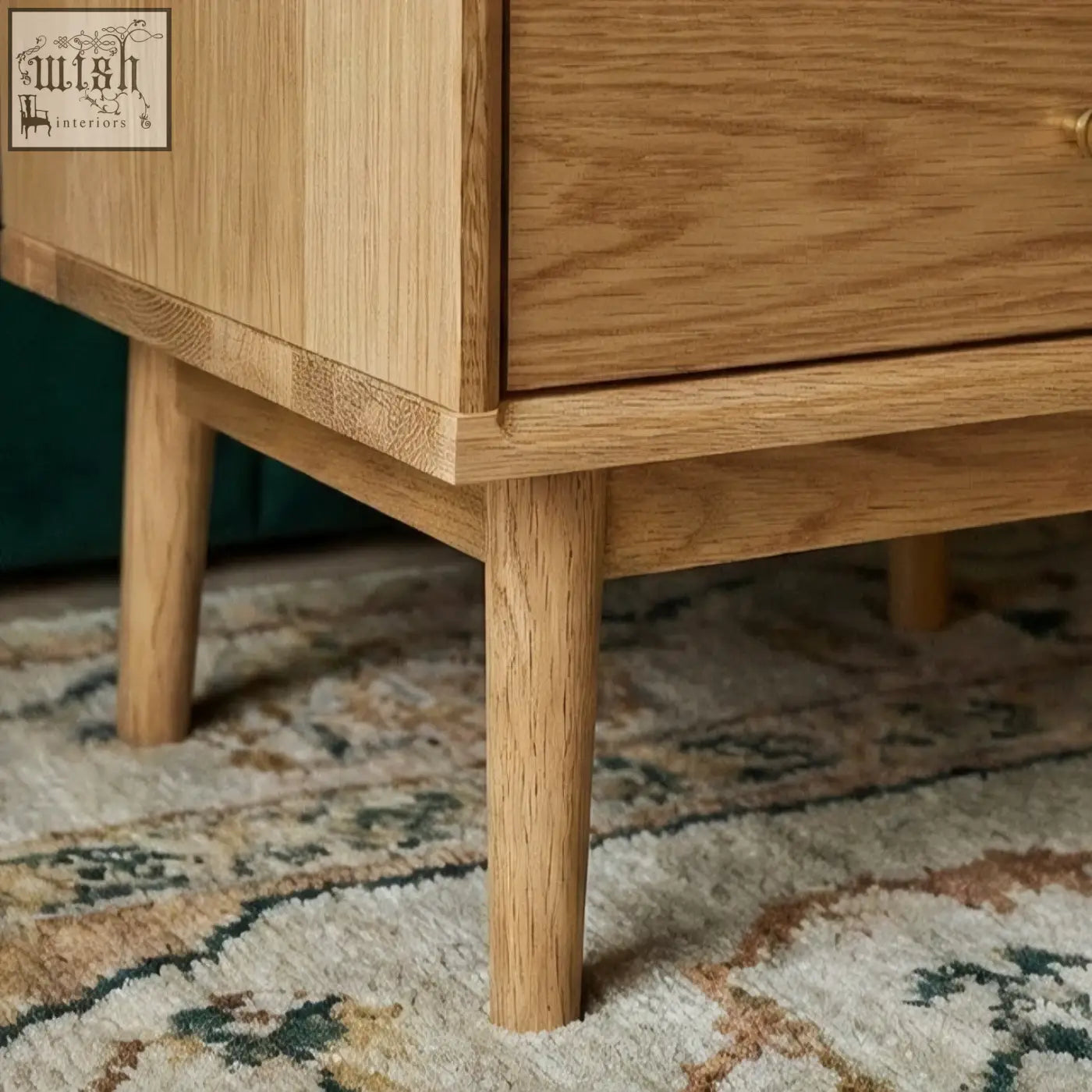 Light oak solid oak bedside table with tapered legs and smooth natural grain finish for bedroom use