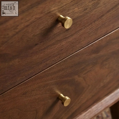 Gold-toned round drawer pulls on a dark solid walnut bedside table for stylish walnut bedside storage