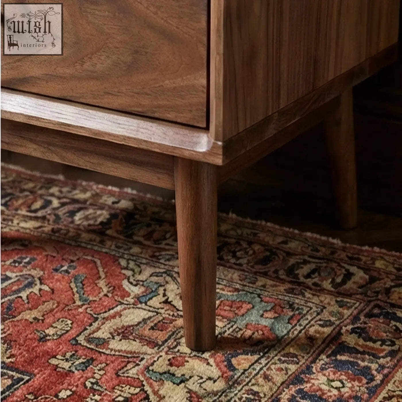 A warm medium brown solid walnut bedside table with a smooth finish and tapered legs perfect for any bedroom