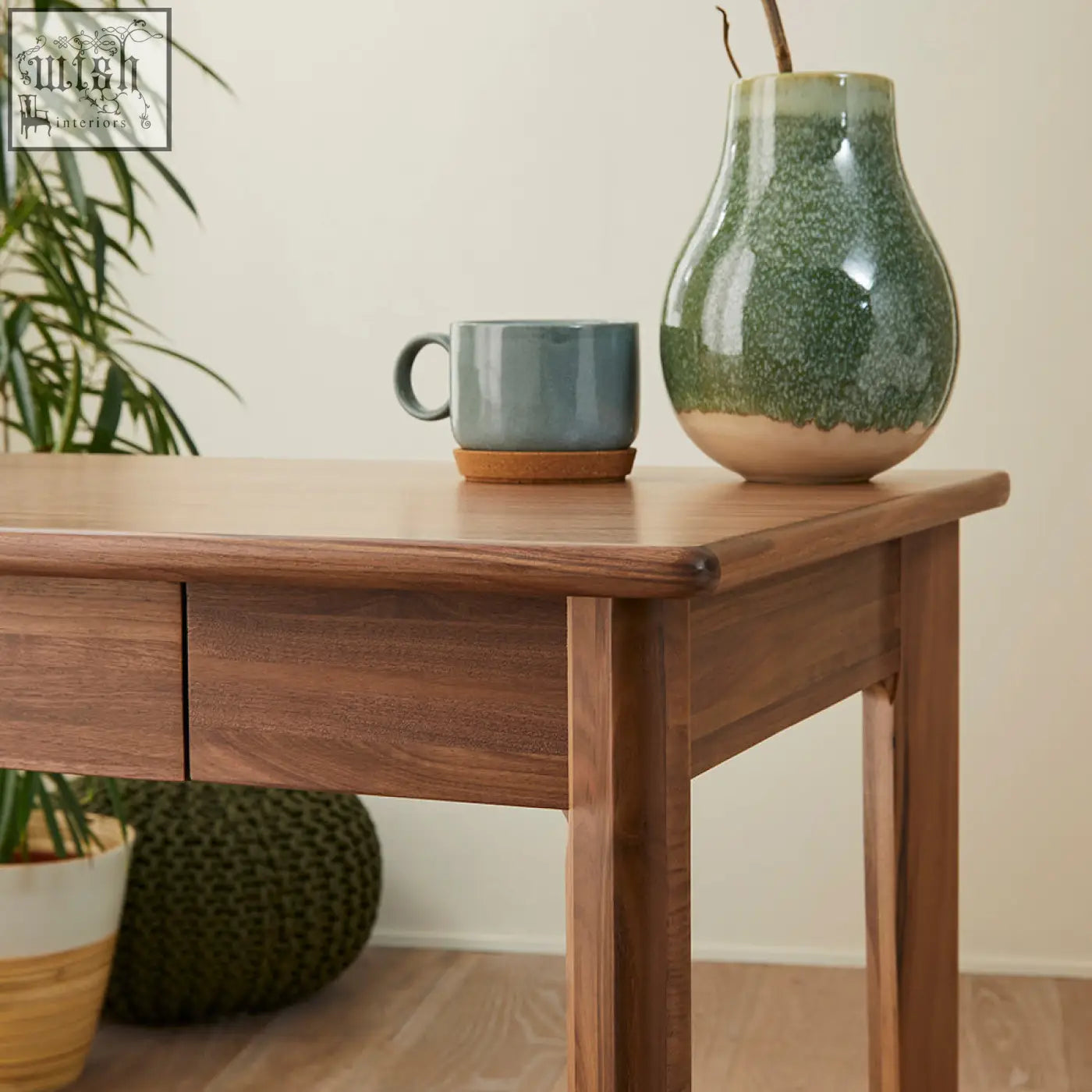 A ceramic vase with speckled green glaze on a beige base displayed on a solid walnut wright walnut desk with wood drawer runners and year warranty