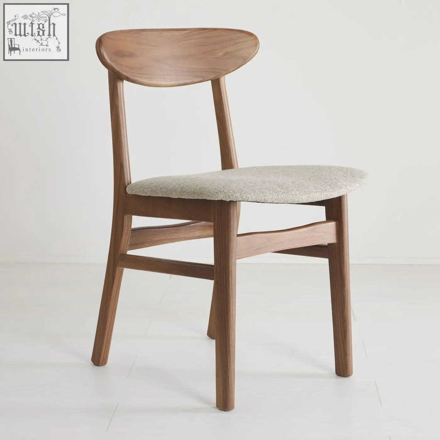 A sleek wright walnut dining chair set of 2 with curved backrest and light gray upholstered seat