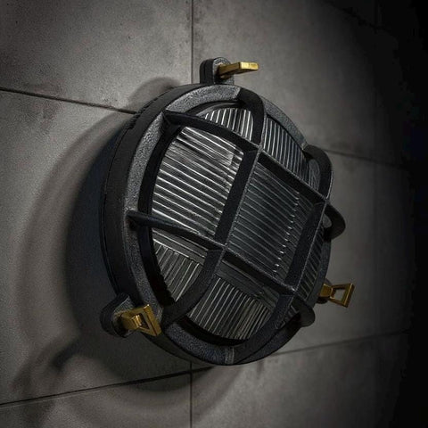 Industrial-style black metal wall light with ribbed grid design and gold hardware nautical bulkhead wall fixture