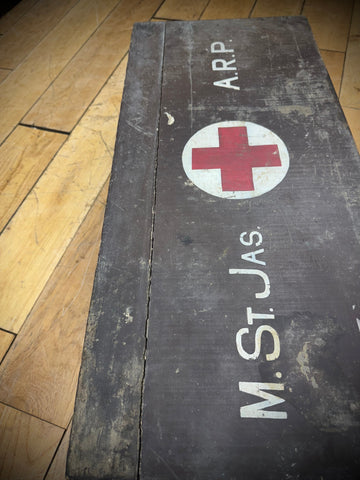 Dark weathered wooden aid box with red cross emblem and arp lettering for civil defence medical use from wwii uk