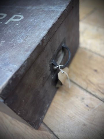 Dark wooden wwii aid box with metal handle and faded red cross lettering for civil defence medical use