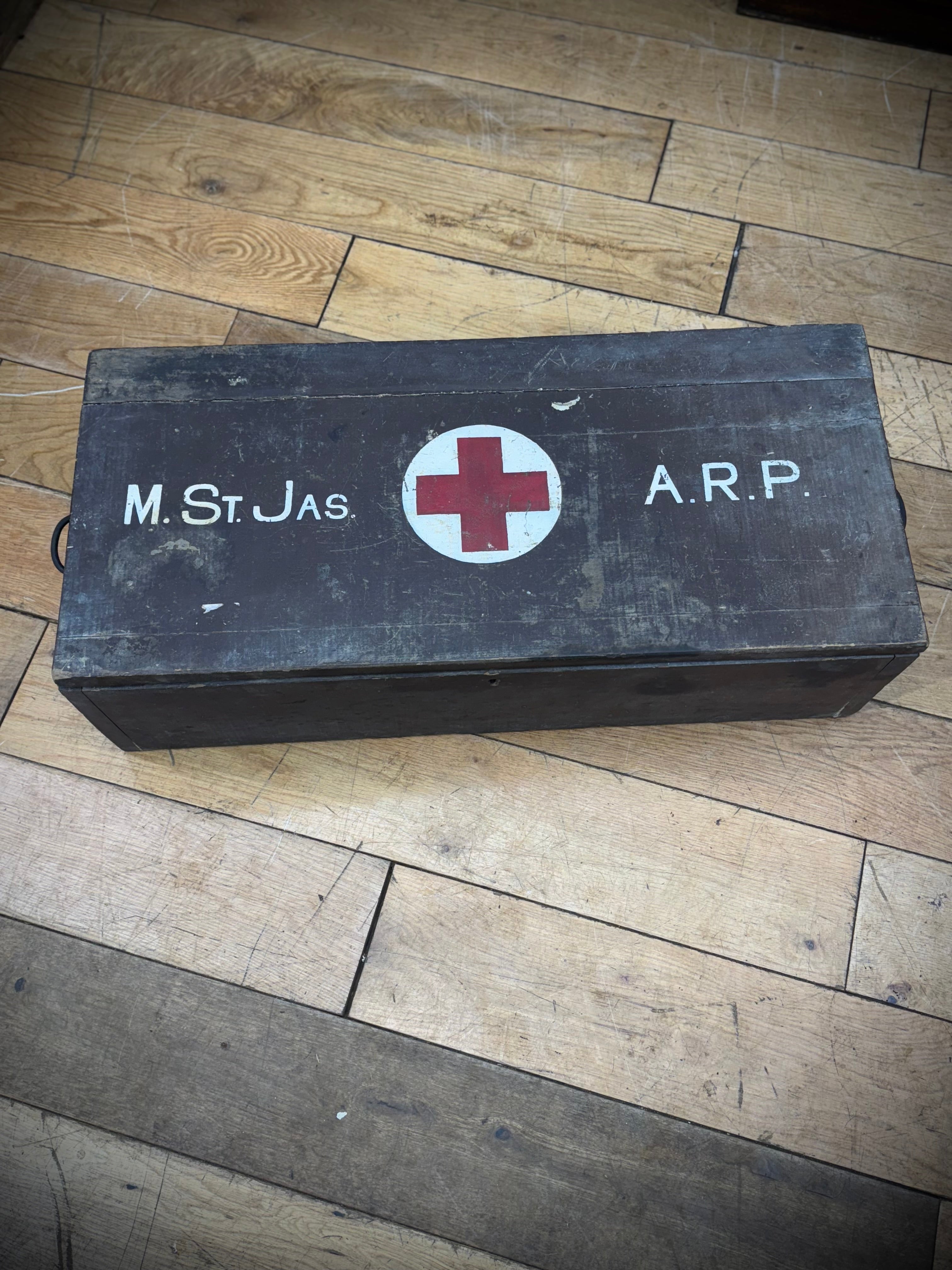 Black wooden wwii civil defence aid box with red cross emblem and white lettering vintage medical storage case