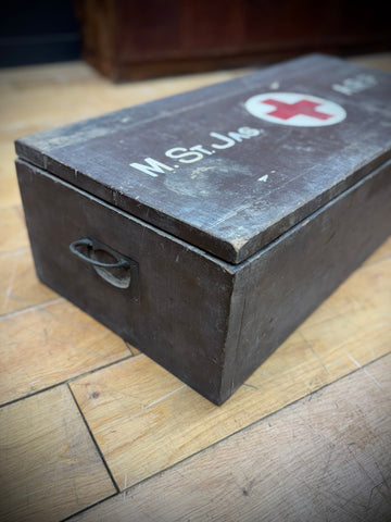 Dark wooden wwii civil defence aid box with red cross emblem and m.st.jac lettering vintage medical case