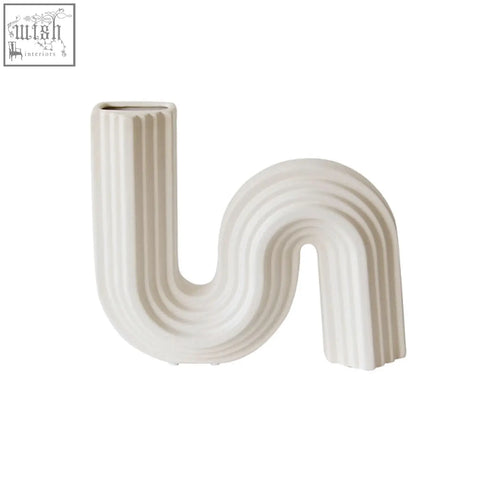 Cream-colored Xenia ceramic shaped vase with s-shaped curve and vertical ridges for stylish home decor