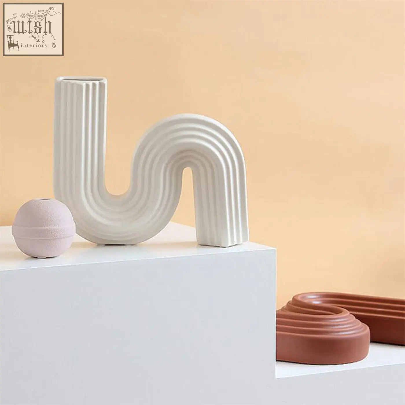 Xenia ceramic shaped vase white ceramic shaped vase with sleek curved s-shape and vertical ridges