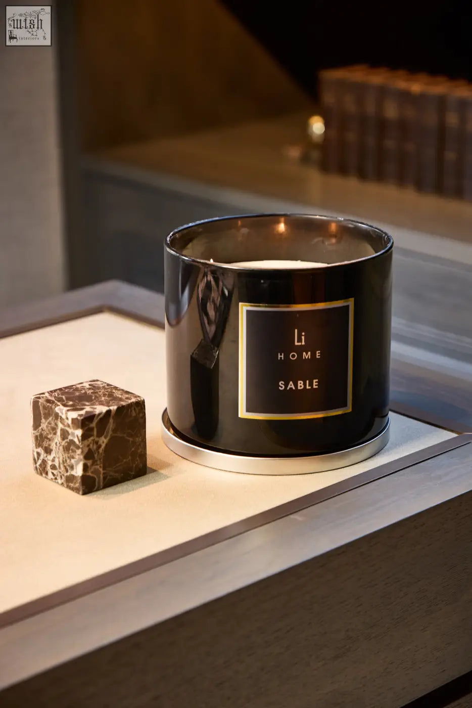 Black cylindrical xl candle with gold trimmed sable label in sleek modern design by li home