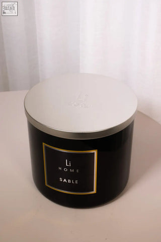 Black xl candle with silver lid and gold trimmed label reading li home sable for cozy home ambiance
