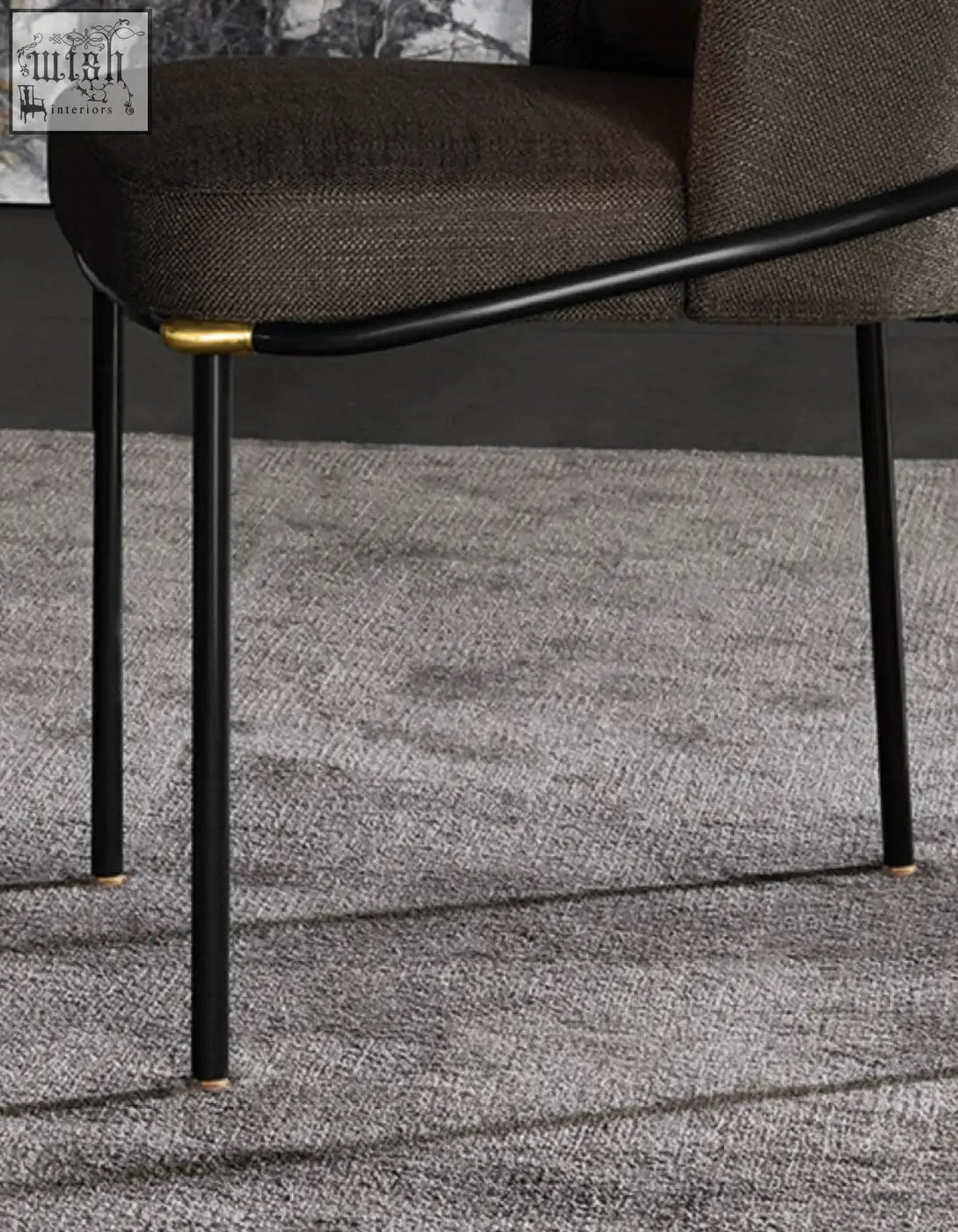 Modern black metal velvet dining chair with dark brown fabric upholstery and gold-tone legs for elegant dining