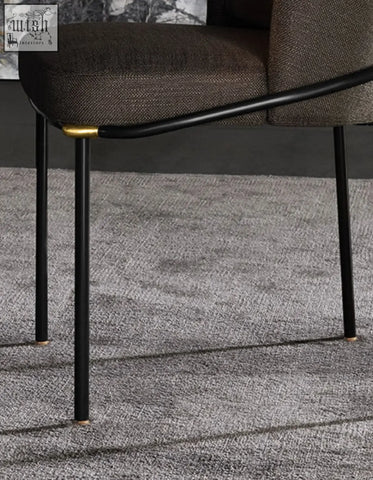 Modern black metal velvet dining chair with dark brown fabric upholstery and gold-tone legs for elegant dining
