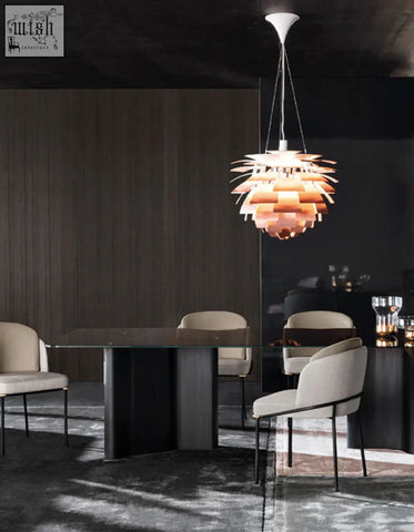 A warm-toned pendant light with layered petal segments above a velvet dining chair for cozy velvet dining vibes