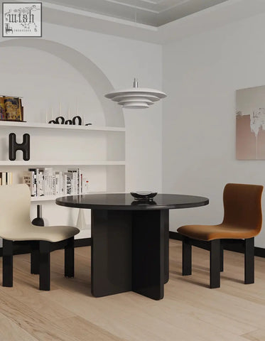 Black round accent dining table with sleek modern design and glossy glass top perfect for dining spaces