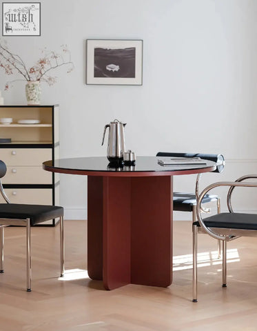 Yadav glass top dining table with a sleek round accent table featuring a glossy black top and reddish-brown base