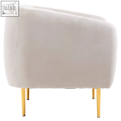 Cream-colored velvet armchair with sleek gold metal legs in the style of yasmeen silver grey velvet armchair
