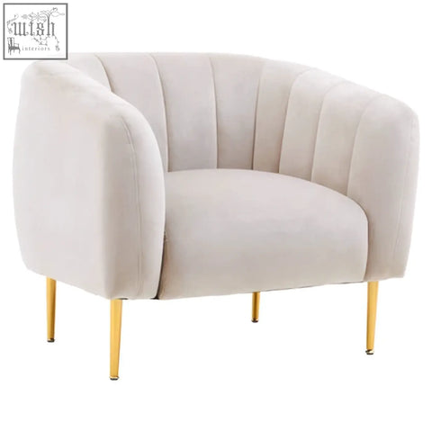 Cream-colored velvet armchair with gold-tone metal legs perfect for a stylish grey velvet armchair setup