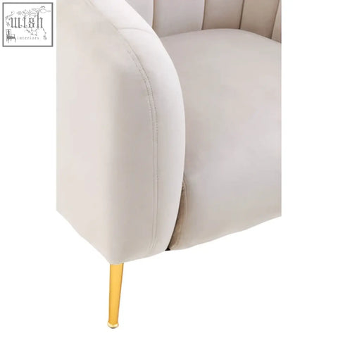 Cream-colored velvet armchair with gold-tone legs contrasting the yasmeen silver grey velvet armchair style