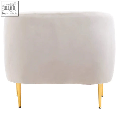Cream-colored velvet armchair with slender gold-tone legs perfect as a stylish grey velvet accent chair