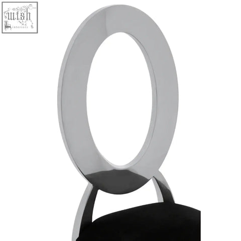 Chrome finished oval ring back of yasmin black velvet dining chair with black upholstered seat visible from back