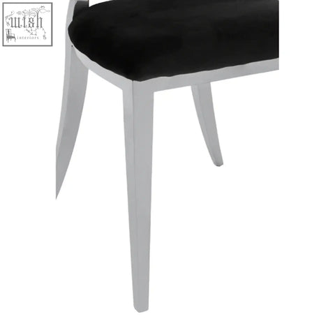 Black velvet dining chair with oval back and sleek silver metal legs perfect for stylish dining spaces