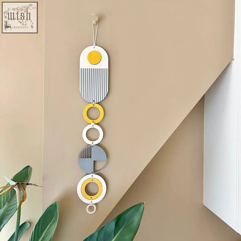 Modern wall hanging with layered circular shapes in ochre yellow gray and silver tones perfect minimalist wall art