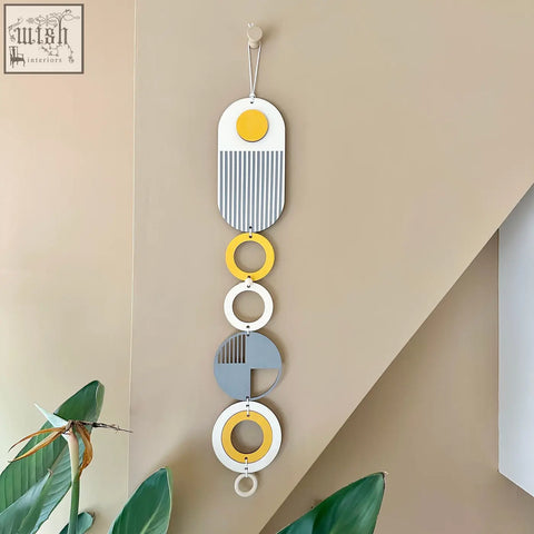 Modern geometric wall hanging with layered ochre yellow, grey, white, and light blue shapes for minimalist wall art