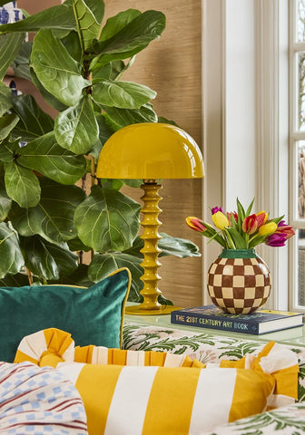 Yellow cabana stripe ruffled cushion cover with bright yellow mushroom-shaped lamp and textured ribbed base