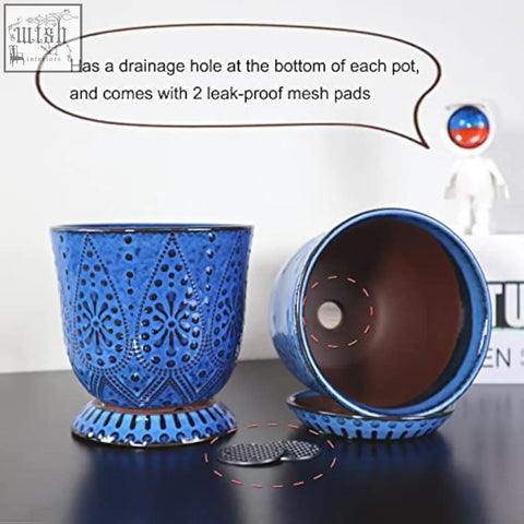 Vibrant blue ceramic flower pot with embossed floral patterns and drain holes perfect for indoor outdoor plants
