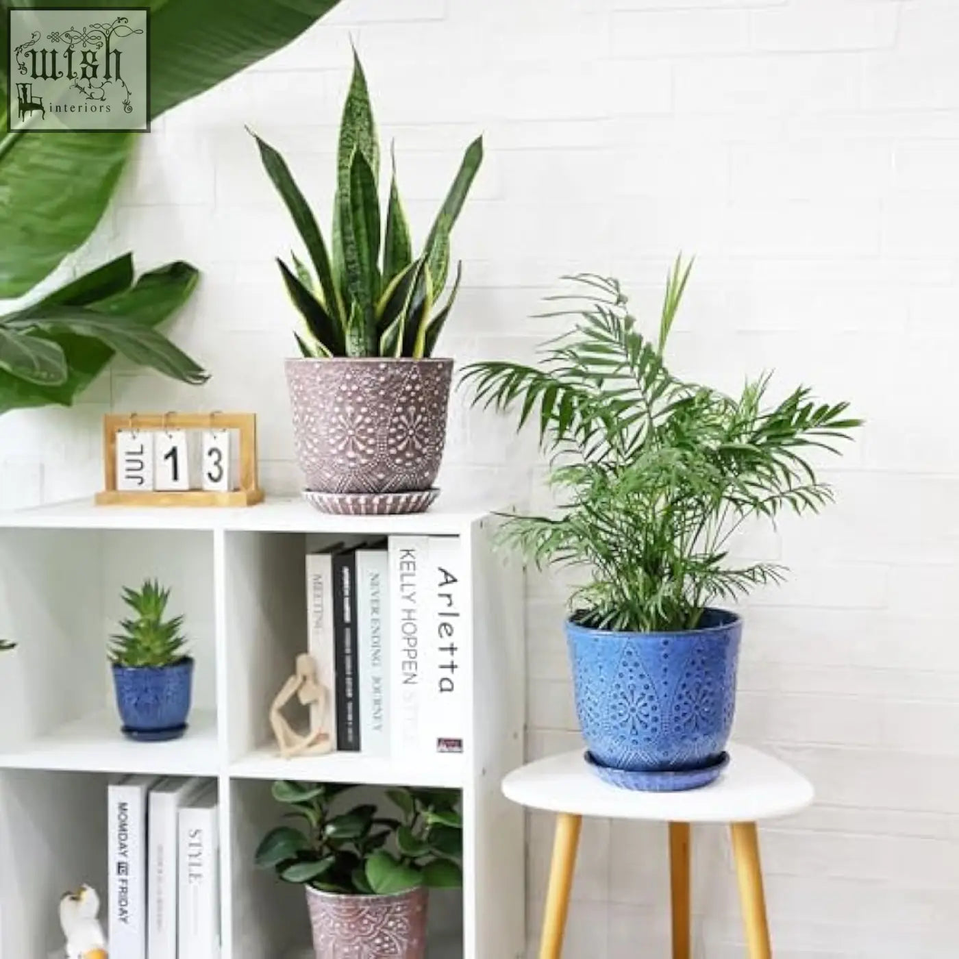 Purple beaded ceramic flower pot with drain holes and embossed pattern holding tall green snake plant indoors