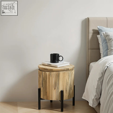 York solid wood bedside table with natural bamboo finish black metal legs topped with books and black mug