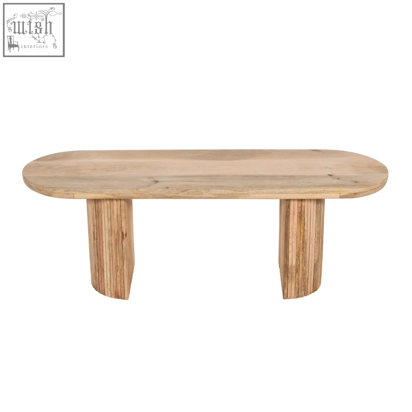 Light-colored solid mango wood dining table with smooth oval top and two fluted pedestal legs perfect for york bench
