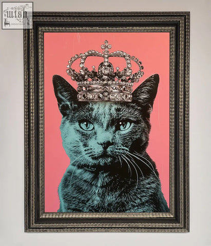 A framed print of a majesty cat framed with a black cat wearing a jeweled silver crown on a vibrant pink background