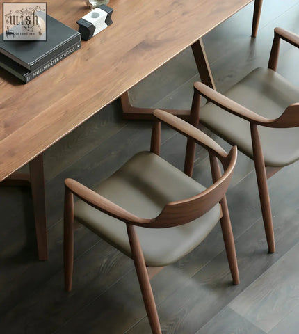 Modern yubi chair with pine wood frame features sleek curved armrests and gray upholstered seats