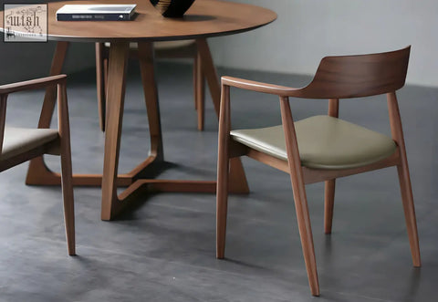 A sleek yubi chair with a pine wood frame and light olive green upholstered seat for stylish dining