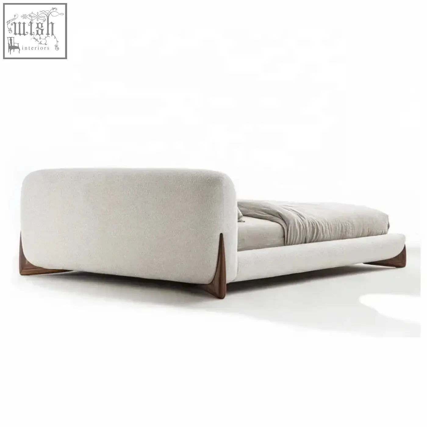 Modern yukina bed with sculptural frame wrapped in soft beige upholstery and sleek dark wood legs